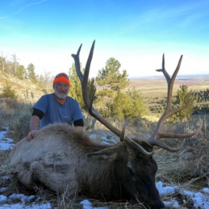 Bull elk hunter with a smile on his face